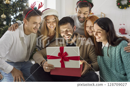 Friends Surprised By A Gift Box During A New Year Or Christmas At Home 128709027