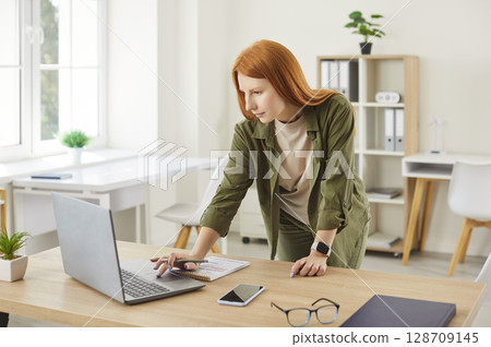 Woman Working Or Studying Online From Her Home Office Woman Working Or Studying Online From Her Home Office 128709145