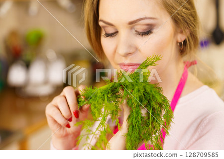 Young woman holding dill herb 128709585