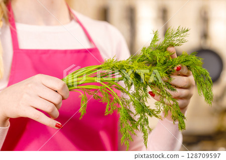 Woman holding green dill herb Woman holding green dill herb 128709597
