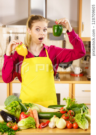Woman holding bell peppers paprika thinking Woman holding bell peppers paprika thinking 128709605