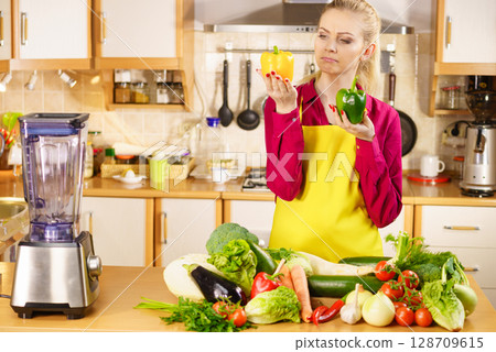 Woman holding bell peppers paprika thinking 128709615