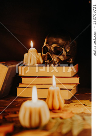 Human Skull with Books and Candles in Dark Witchy Setting. Halloween, gothic Human Skull with Books and Candles in Dark Witchy Setting. Halloween, gothic 128709721