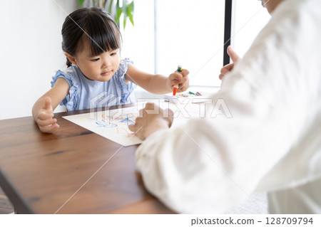 Educational scene of a girl enjoying drawing with crayons Educational scene of a girl enjoying drawing with crayons 128709794