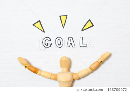 A drawing doll is showing the word GOAL A drawing doll is showing the word GOAL 128709972