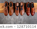 Elegant Brown Leather Shoes Collection on Wooden Shelf 128710114