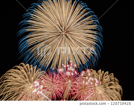 Golden fireworks filling the night sky Golden fireworks filling the night sky 128710428