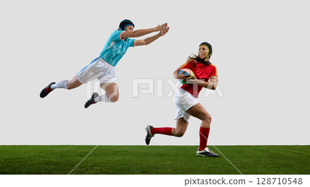 Dynamic rugby match with female athletes in action on field Dynamic rugby match with female athletes in action on field 128710548
