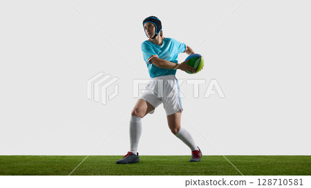 Woman rugby athlete active on field wearing sports attire and safety helmet Woman rugby athlete active on field wearing sports attire and safety helmet 128710581