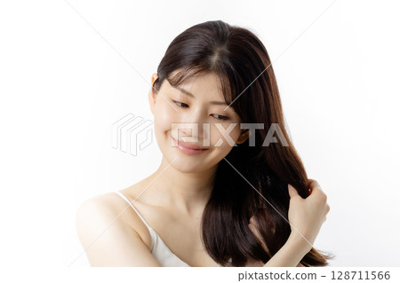 Young woman taking care of her hair 128711566