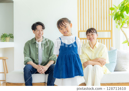 A family relaxing in the living room A family relaxing in the living room 128711610