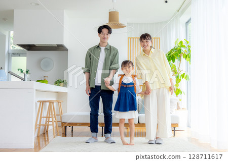 A family relaxing in the living room A family relaxing in the living room 128711617