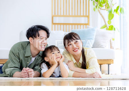 A young family relaxing in the living room A young family relaxing in the living room 128711628
