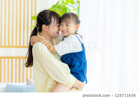 Mother and daughter 128711636