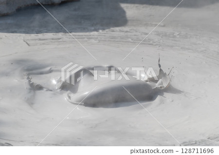 Beppu Bozu Jigoku: A geothermal scene of mud spewing out 128711696