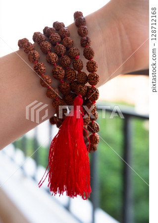 Japamala on the hand. Prayer beads. Religious equipment Japamala on the hand. Prayer beads. Religious equipment 128712168