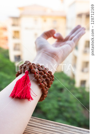 Japamala on the hand. Prayer beads. Religious equipment 128712169