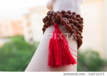 Japamala on the hand. Prayer beads. Religious equipment Japamala on the hand. Prayer beads. Religious equipment 128712171