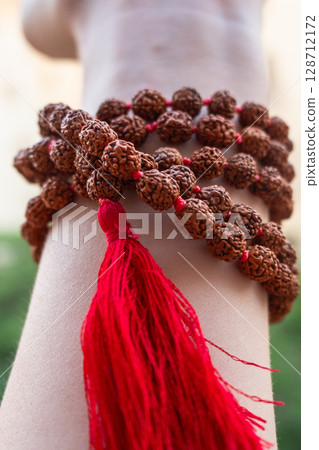 Japamala on the hand. Prayer beads. Religious equipment Japamala on the hand. Prayer beads. Religious equipment 128712172