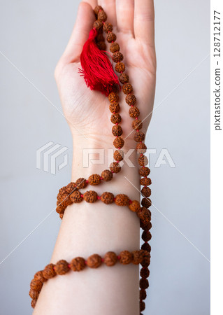 Japamala on the hand. Prayer beads. Religious equipment Japamala on the hand. Prayer beads. Religious equipment 128712177