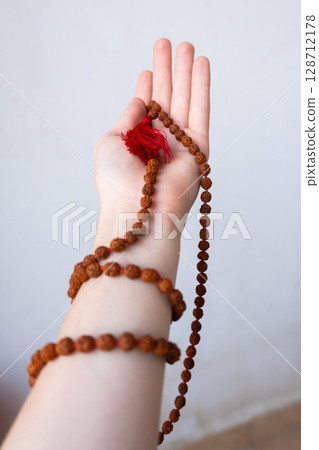 Japamala on the hand. Prayer beads. Religious equipment Japamala on the hand. Prayer beads. Religious equipment 128712178
