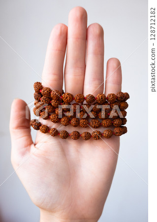 Japamala on the hand. Prayer beads. Religious equipment Japamala on the hand. Prayer beads. Religious equipment 128712182