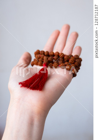 Japamala on the hand. Prayer beads. Religious equipment Japamala on the hand. Prayer beads. Religious equipment 128712187