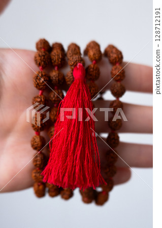 Japamala on the hand. Prayer beads. Religious equipment Japamala on the hand. Prayer beads. Religious equipment 128712191