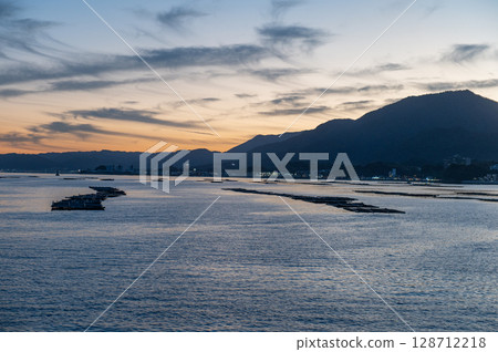 The Seto Inland Sea and oyster rafts at dusk (Miyajima, Hiroshima) 128712218