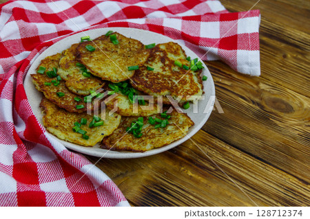 Potato pancakes on a wooden table 128712374