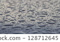 Raindrops on blue car roof - selective focus surface texture 128712645
