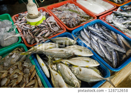 Asian fish market, fresh seafood assortment with various types of fish on trays 128712658