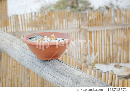 A special ashtray at the non-smoking beach Spiaggia La Cinta in San Teodoro, Olbia, Sardinia. Impact of smoking on natural areas concept A special ashtray at the non-smoking beach Spiaggia La Cinta in San Teodoro, Olbia, Sardinia. Impact of smoking on natural areas concept 128712771