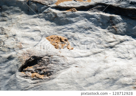 Close-up of a natural quartz formation inside a cave. The detailed crystal structure and layers of the mineral Close-up of a natural quartz formation inside a cave. The detailed crystal structure and layers of the mineral 128712928