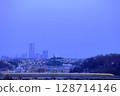 Doctor Yellow running with the buildings of Minato Mirai in the evening skyline in the background 128714146