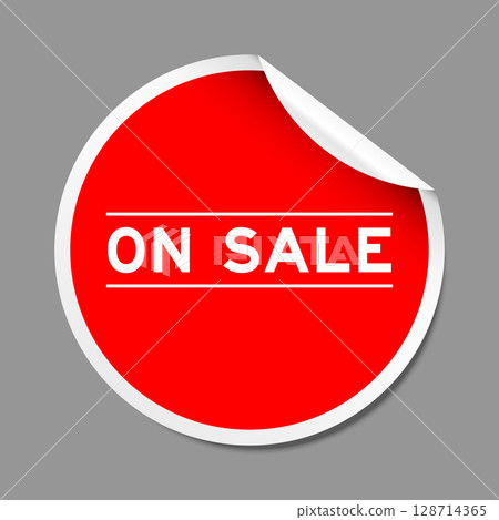 Red color peel sticker label with word on sale on gray background 128714365