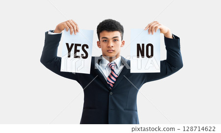 A young foreign male businessman worried about whether to answer yes or no 128714622