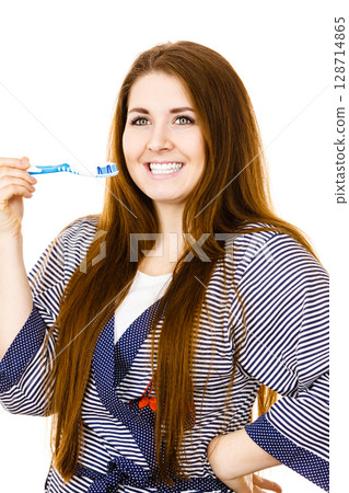 Woman holds toothbrush with paste. Woman holds toothbrush with paste. 128714865