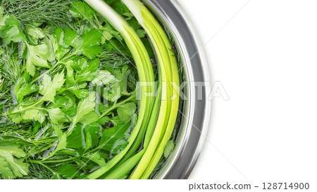 Fresh organic raw greenery. Parsley, dill, cilantro and green onion in water in bowl on white background with copy space. Vegan, vegetarian and healthy food concept. Closeup, flat lay Fresh organic raw greenery. Parsley, dill, cilantro and green onion in water in bowl on white background with copy space. Vegan, vegetarian and healthy food concept. Closeup, flat lay 128714900