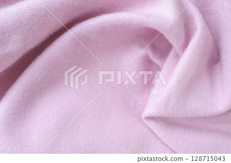 Cashmere pink stole. Texture, background, drapery. Fabric made of natural wool and silk, pastel pink color. 128715043