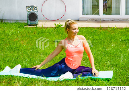 Woman doing exercises gym in garden at home Woman doing exercises gym in garden at home 128715132