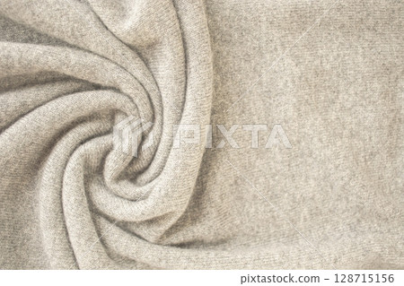 Cashmere beige fabric, top view. Draped, texture, background. Natural wool clothing. 128715156