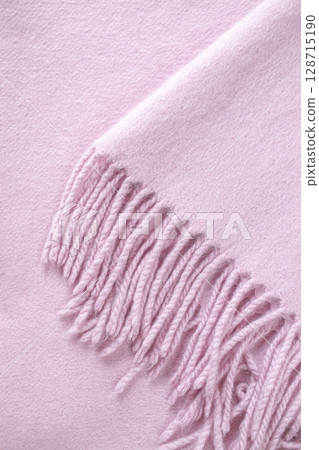 Cashmere pink stole. Texture, background, drapery. Fabric made of natural wool and silk, pastel pink color. 128715190