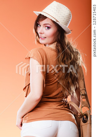 Lovely woman in summer hat handbag portrait 128715403