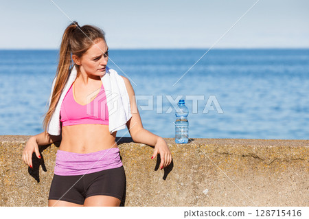 Woman drinking water after sport gym outdoor Woman drinking water after sport gym outdoor 128715416