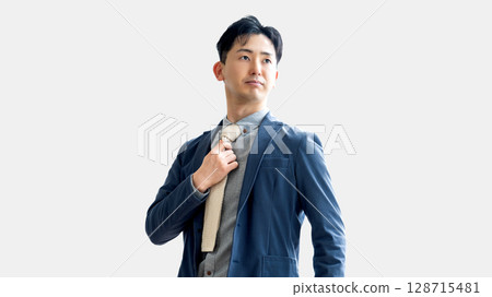 Male businessman tightening his tie Male businessman tightening his tie 128715481