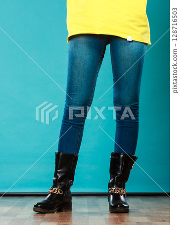 woman legs in denim trousers boots woman legs in denim trousers boots 128716503