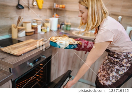 Baking a delicious pie in a cozy kitchen during the afternoon 128716525