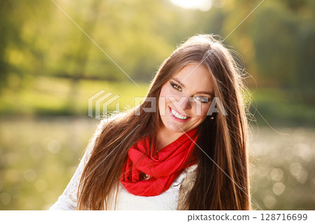 Portrait girl relaxing walking in autumnal park. 128716699
