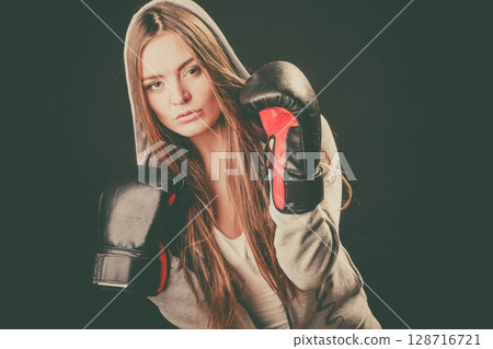 Woman wear hoodie and boxer gloves. Woman wear hoodie and boxer gloves. 128716721